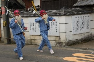 Tengu walking through Japanese towns