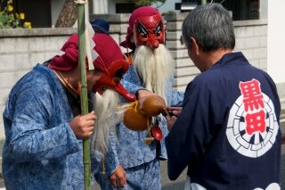 Tengu serving sake during festival